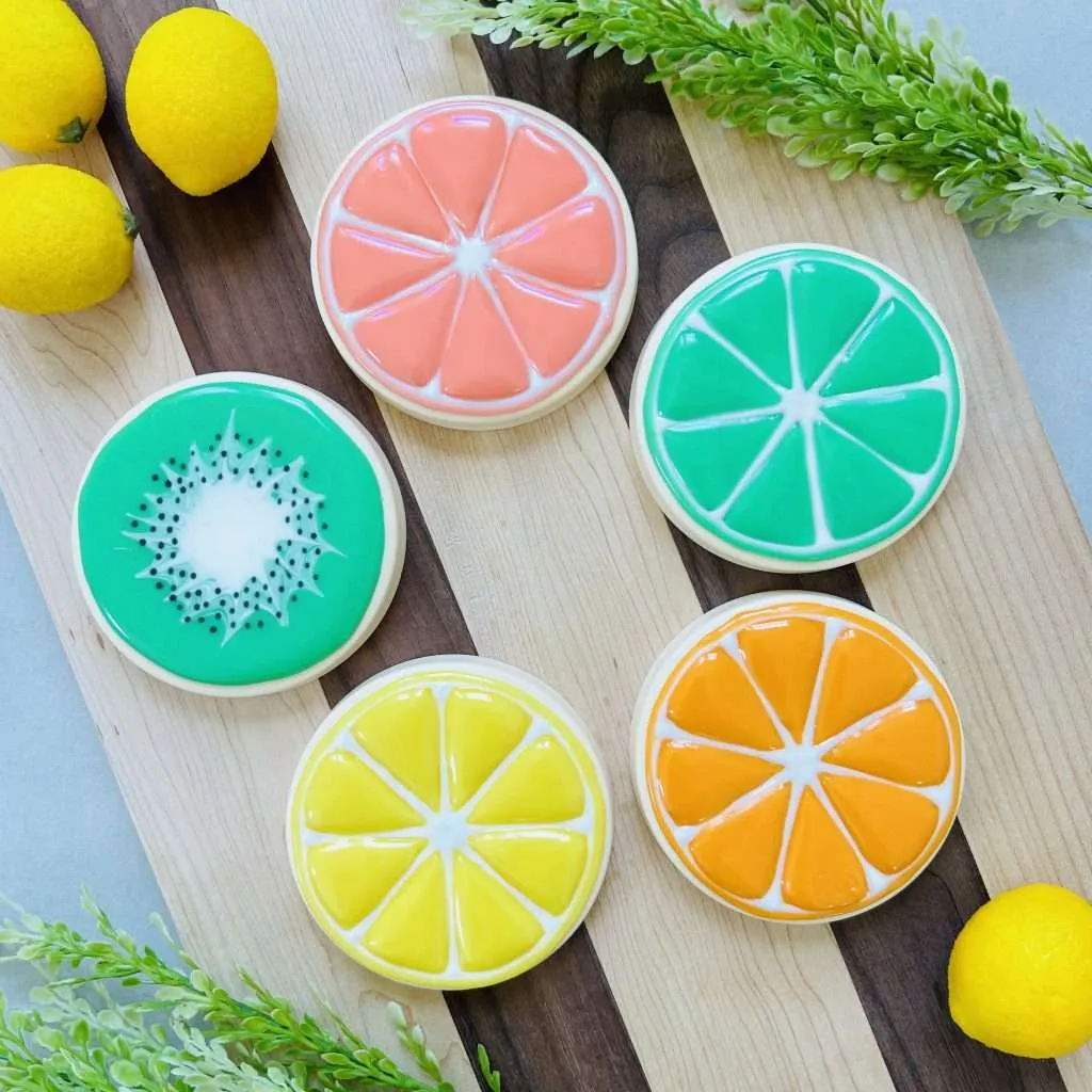 cookies decorated in a summer fruit theme of grapefruit, lime, orange, lemon and kiwi