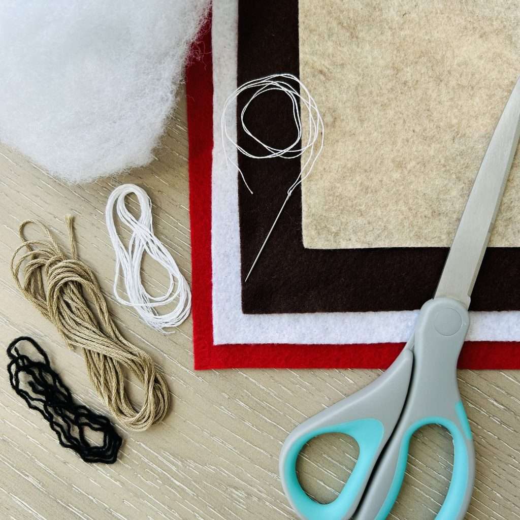 4 sheets of felt in red, white, walnut brown and sandstone, stuffing, embroidery thread in black, mocha brown and Snow White, a pair of scissors and embroidery needle