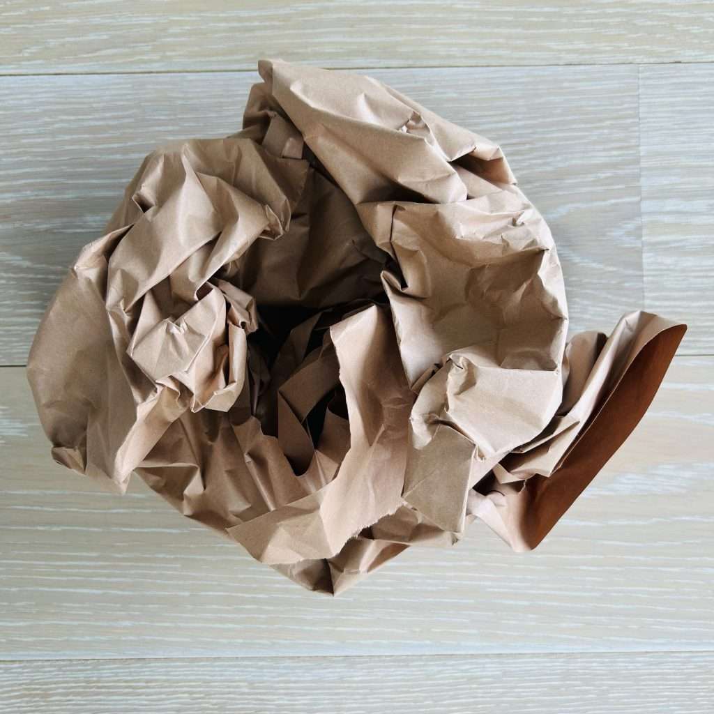 crumbled up brown shipping paper