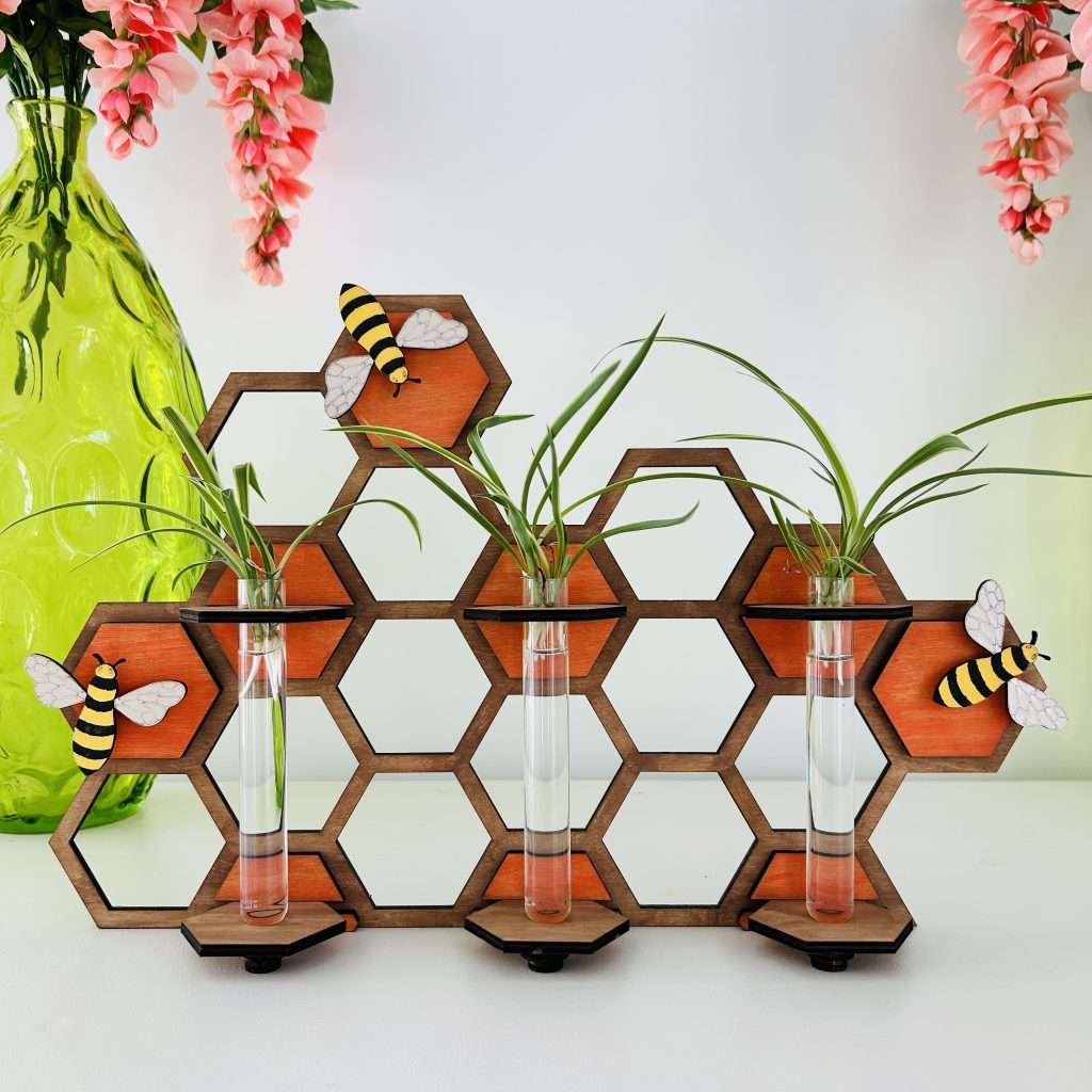 Buzz and Grow Plant Propagation Station with stand. Wooden honeycomb with 3 test tubes holding spider plant pups for propagation
